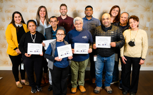 Six janitors, above, graduated from a 30-hour curriculum on green and sustainable practices. (Molly J. Smith/Adobe Stock)