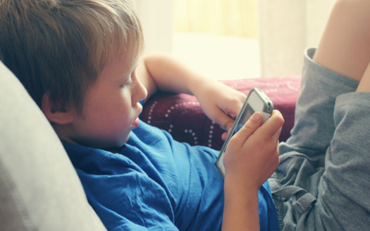 Seven in 10 parents say their kids have interacted with a smartphone before age 11. (dubova/Adobe Stock)
