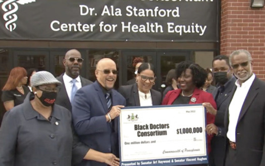 Philadelphia lawmakers present a check for $1 million to Tracy Wood, executive director of Black Doctors Consortium. (Screenshot via Facebook Live)