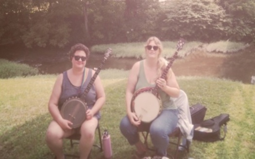 Larah Helayne, left, and Montana Hobbs, right. Helayne uses a rainbow strap for their banjo to highlight their LGBTQ+ identity. Others at Cowan did the same. (Rebecca Stern)
