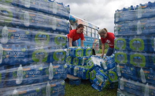 Save the Children staff at an elementary school in Perry County, preparing to distribute bottled water and supplies to residents. (Save the Children)