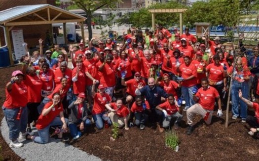 AARP Maryland volunteers celebrated after the initial construction of a park and garden space at Baltimore's James McHenry Elementary School was completed in 2018. (Todd Nash)