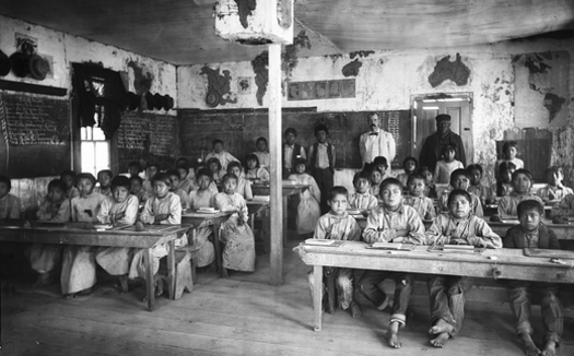 Native American students, girls on the right and boys on the left, attend class at the Walapai Indian School in Kingman, Ariz., around 1900. (Wikimedia)