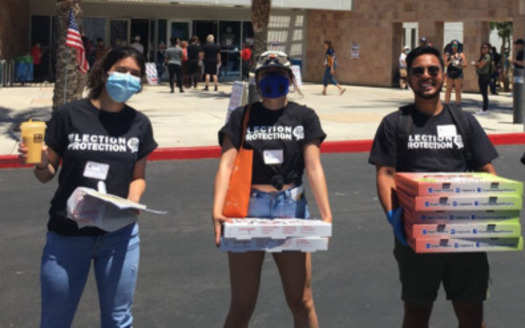 Volunteers from the group Election Protection coalition recently handed out food to voters in line at the Desert Breeze Community Center in Las Vegas; the group will be on hand today to answer questions at polling sites around the state. (Silver State Voices)