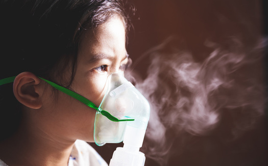 Children living near refineries, highways and other sources of air pollution are disproportionately at risk of developing respiratory illness. (Adobe Stock)