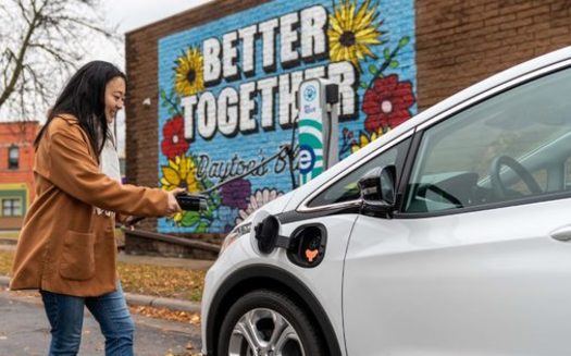 A user plugs an Evie electric vehicle into a charging station as part of its car-sharing program. (Photo courtesy Evie Carshare)