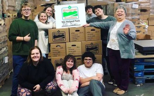 Volunteers pack boxes at Mountaineer Food Bank in Gassaway, West Virginia. (Mountaineer Food Bank/Facebook)<br />