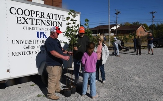 Master Gardeners Nate Picken and Frank Amaro along with Pembroke Mayor Judy Peterson help Avery Grace select trees to be planted at Pembroke School. (Photo courtesy Toni Riley)