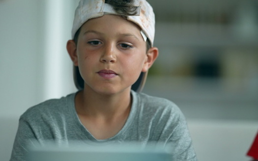Eye doctors warn that kids who spend excessive time on laptops, cell phones and tablets could end up with vision problems as adults. (Marco/Adobe Stock)