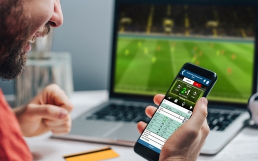 Problem gambling experts say commercials for sports-betting apps often portray the activity as a fun, social event, with not enough information about the potential risks. (wpadington/Adobe Stock)<br />