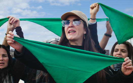 The green scarf is a symbol of the abortion-rights movements, created in Argentina in 2003 and popularized in the United States in 2022. (Clara/Adobe Stock)