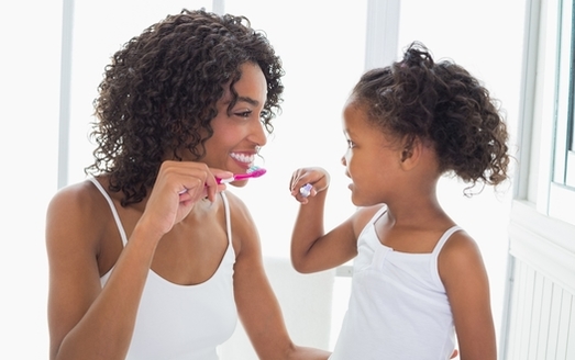 According to the CDC, children who regularly see a dentist and brush daily with fluoride toothpaste are likely to have fewer dental problems as adults. (Adobe Stock)