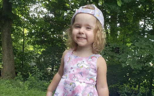 East Palestine, Ohio, resident Kyla Rose Cozza, 3, plays in her backyard just a few steps away from one of the creeks now contaminated with toxic chemicals after a massive train derailment Feb. 3. (Jamie Cozza)<br />