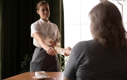 Tipped workers, such as waiters, must depend on the generosity of their customers to make a living wage. (Adobe Stock)