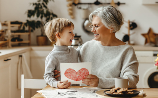 Working caregivers face financial risks such as lost income, reduced career opportunities and subsequently lower Social Security and retirement benefits, according to AARP. (Adobe Stock)<br />