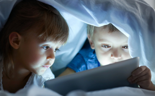 Elementary students who spend more than two hours a day on screens are more likely to have emotional, social and attention problems, while students who have screens in their bedrooms tend to perform worse on academic tests than do those who do not. (Adobe Stock) 