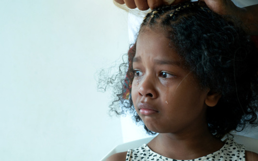 Black people, especially women and girls, have endured countless hair services, sometimes painful and damaging to the hair, to maintain hairstyles that might make them less likely to encounter discrimination. (chomplearn_2001/Adobe Stock)