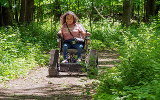 The Minnesota Department of Natural Resources offers all-terrain track chairs at selected sites. The battery-powered chairs give visitors with mobility disabilities a chance to explore state park trails that cannot be accessed using a regular wheelchair. (Photo courtesy of DNR)