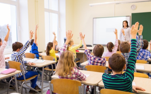 Health experts say if a student in the classroom is the only one not frequently raising their hand to answer a question, it might signal a deeper issue, such as hearing loss. (Adobe Stock)