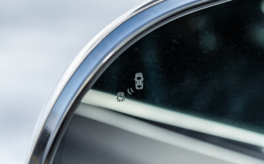 A blind spot monitoring system can help a driver avoid a collision. (Roman/Adobe Stock)