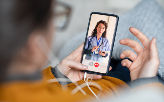 Experts recommend checking into telehealth offerings when researching health plans ahead of the open-enrollment period. (Rido/Adobestock)
