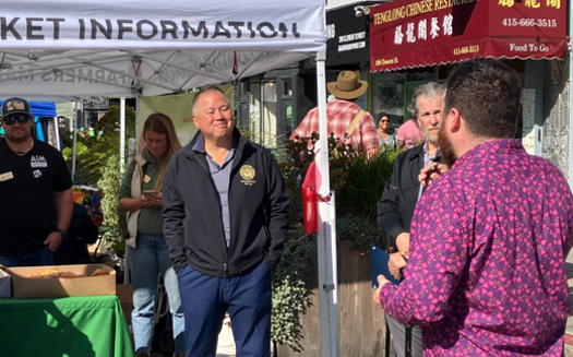 Assemblyman Phil Ting, D-San Francisco, speaks with Andy Naja-Riese of the Agricultural Institute of Marin at the Clement Street Farmer's Market in San Francisco. (Felice Thorpe)