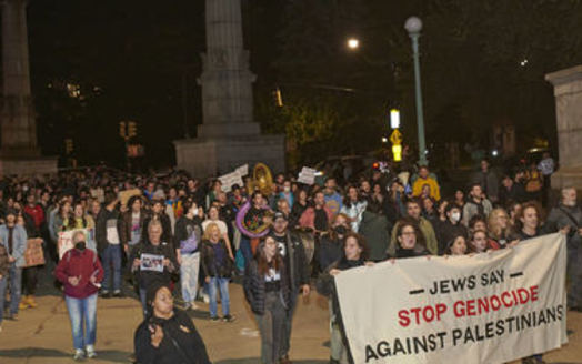 Jewish Americans hold up signs, including 