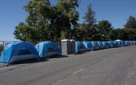 Researchers are looking into whether reflective white paint on asphalt could reduce surface temperatures and thus reduce suffering in areas that host people experiencing homelessness. (Renee C. Byer/Sacramento Bee)