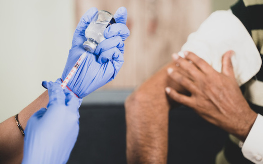 The latest KFF survey reveals one in six respondents say they can't afford to take time off work to get a COVID-19 vaccine, including more than one-third of Hispanic adults and one-in-five Black adults. (Lakshmiprasad/Adobe Stock)