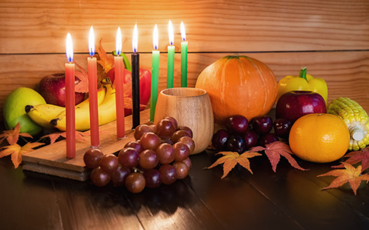 The seven candles in the kinara hold distinct meanings. Red reflects the struggle of Africans, green represents hope and the future, and black represents the African culture. (Adobe Stock)