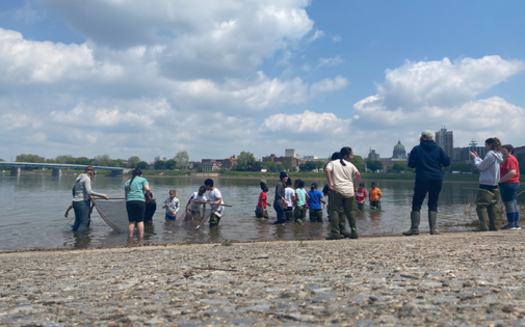 Chesapeake Bay Foundation educators, with students on a field trip, explore the Susquehanna River at City Island. The Capitol building is in the background. (Chesapeake Bay Foundation) 