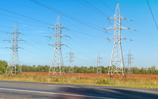 Many transmission projects already follow highway corridors, but depending on the state, policy experts say laws can make it harder to add new power lines along federal interstates. (Adobe Stock)