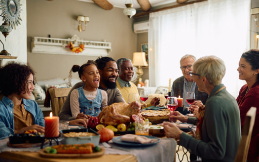 Economists suggest for a more budget-friendly holiday feast, consider hosting a potluck. Sharing dishes not only brings variety to the table, but helps spread the costs among guests. (Drazen/Adobe Stock)