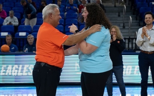Florida Gulf Coast University student Zoe Horowitz meets the recipient of her stem cells, Kevin Mitchell, for the first time at an women's basketball game. (Sarah Passey)