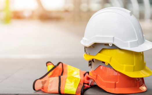Federal officials said construction vests too small for larger workers could limit their mobility in a dangerous situation on a job site, one reason why they are moving forward with a new rule requiring such gear to properly fit all workers. (Adobe Stock)