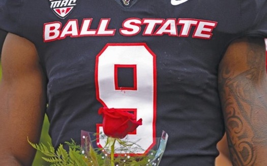 Ball State linebacker Kieonte Newson holds a rose for his mother on Senior Day, a moment of restoration after earning the number nine. (T Slaughter/Daily News)