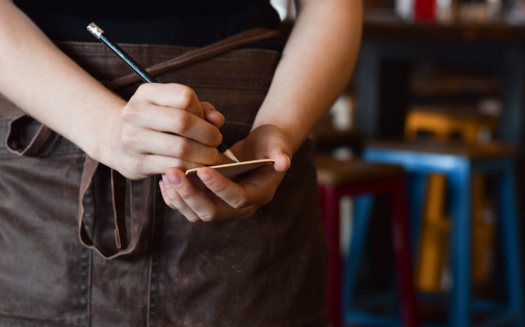 Economists say minimum wage hikes can be a complex issue to sort out. But some say when you look past the numbers, higher wages can help boost morale and reduce the need to keep hiring new staff. (Adobe Stock)