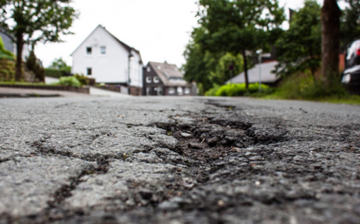 When corporate-sized farms gain a presence in rural communities, skeptics said the added economic activity can have side effects, such as larger trucks leading to deteriorated roads. (Adobe Stock)