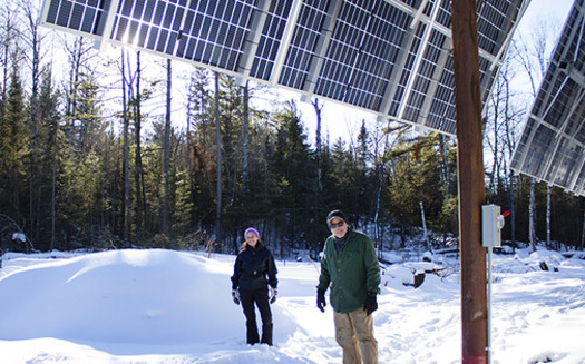 Daniel Houle and Denise Myers stand in front of their new solar setup at the Lodge of Whispering Pines along the Boundary Waters Canoe Wilderness. The system has 72 panels and can generate a total of 38 kilowatts per hour. (Photo courtesy of Ava Kian with MinnPost)
