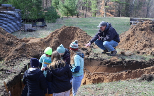 Gregor Willms assists the Cedarburg High School team in the soil pit at Envirothon 2024. (Wisconsin Land and Water Conservation Association)