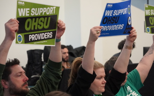 Advanced Practice Providers hold up signs during the OHSU Board of Directors' public session on April 25. (Oregon Nurses Association)