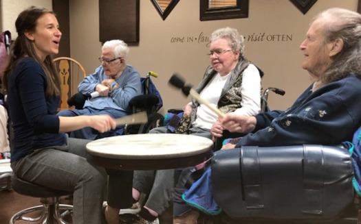 Board-certified music therapist Stephanie Johnson, left, works with older adults in a drumming circle through Music Speaks. Her work is part of a movement to bring more signing and music opportunities to people diagnosed with dementia. (Photo courtesy Music Speaks)