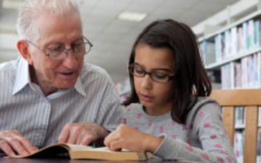 PHOTO: Grandfather reading to child