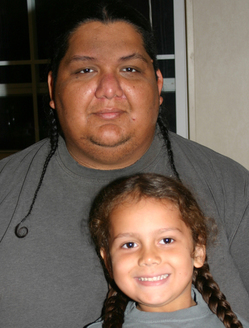 Kenney Arocha and his son, Adriel, who successfully argued in 2009 for a religious exemption from the Needville school district dress code because Adriel's braids were an expression of his Native American faith. Courtesy ACLU of Texas.