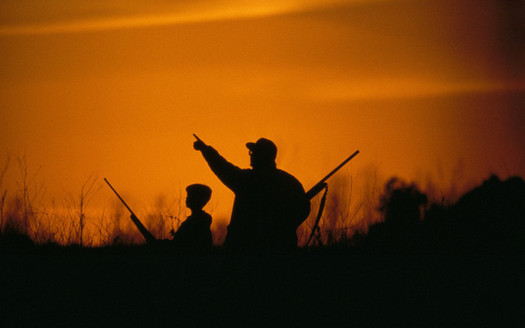 PHOTO: Man and youth hunting at sunrise. Photo credit: USFWS