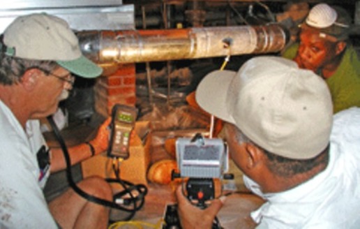 PHOTO: Men testing a furnace.