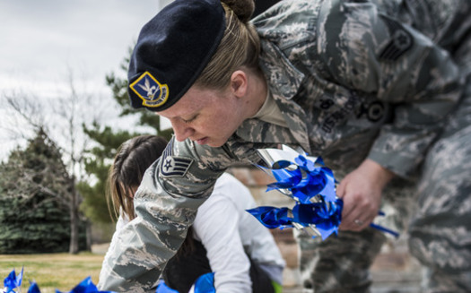 PHOTO: U.S. Air Force Staff Sgt. Sarah Hurtado, 366th Security Forces Squadron, plants pinwheels near the main gate at Mountain Home Air Force Base, Idaho, in recognition of Child Abuse Prevention Month. Photo credit: U.S. Air Force Tech. Sgt. Samuel Morse