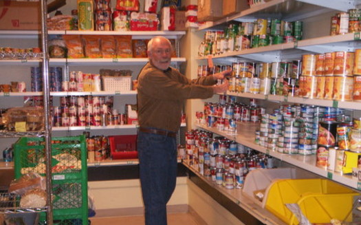 PHOTO: A volunteer stocks shelves at one of the Utah Food Bank's partner food pantries around the state. Courtesy Utah Food Bank.
