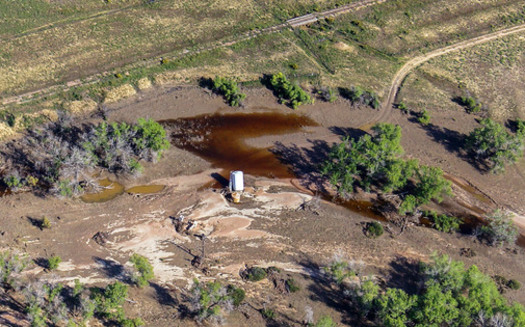 PHOTO: Crude oil leaking after flood near the South Platte River along the Front Range of Colorado in September 2013. Photo courtesy of EcoFlight, ecoflight.org.