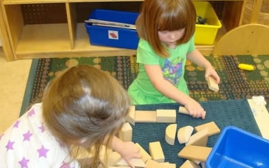 PHOTO: Child care is a major expense in Illinois family budgets, and a new report finds the cost of day care grew up to eight times faster than the average family's income in 2012. Photo: girls playing with blocks. Credit: M.Kuhlman